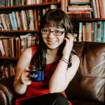 a woman wearing glasses smiling