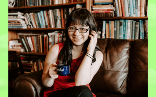 a woman wearing glasses smiling