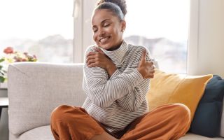woman hugging herself - selfcompassion