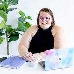 a woman sitting at a desk-Sammy Bohannon
