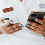 person holding two phones to navigate praise and criticism