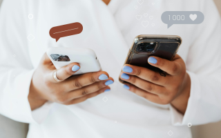 person holding two phones to navigate praise and criticism