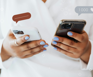 person holding two phones to navigate praise and criticism