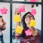 a man and two women brainstorming business ideas