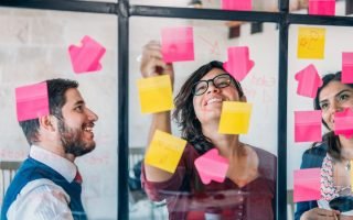 a man and two women brainstorming business ideas