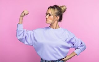 confident introvert - woman making a fist