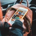 woman scrolling on phone -marketing without social media