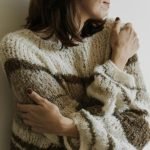 A woman hugging herself - self- acceptance journey