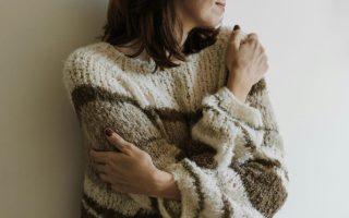 A woman hugging herself - self- acceptance journey